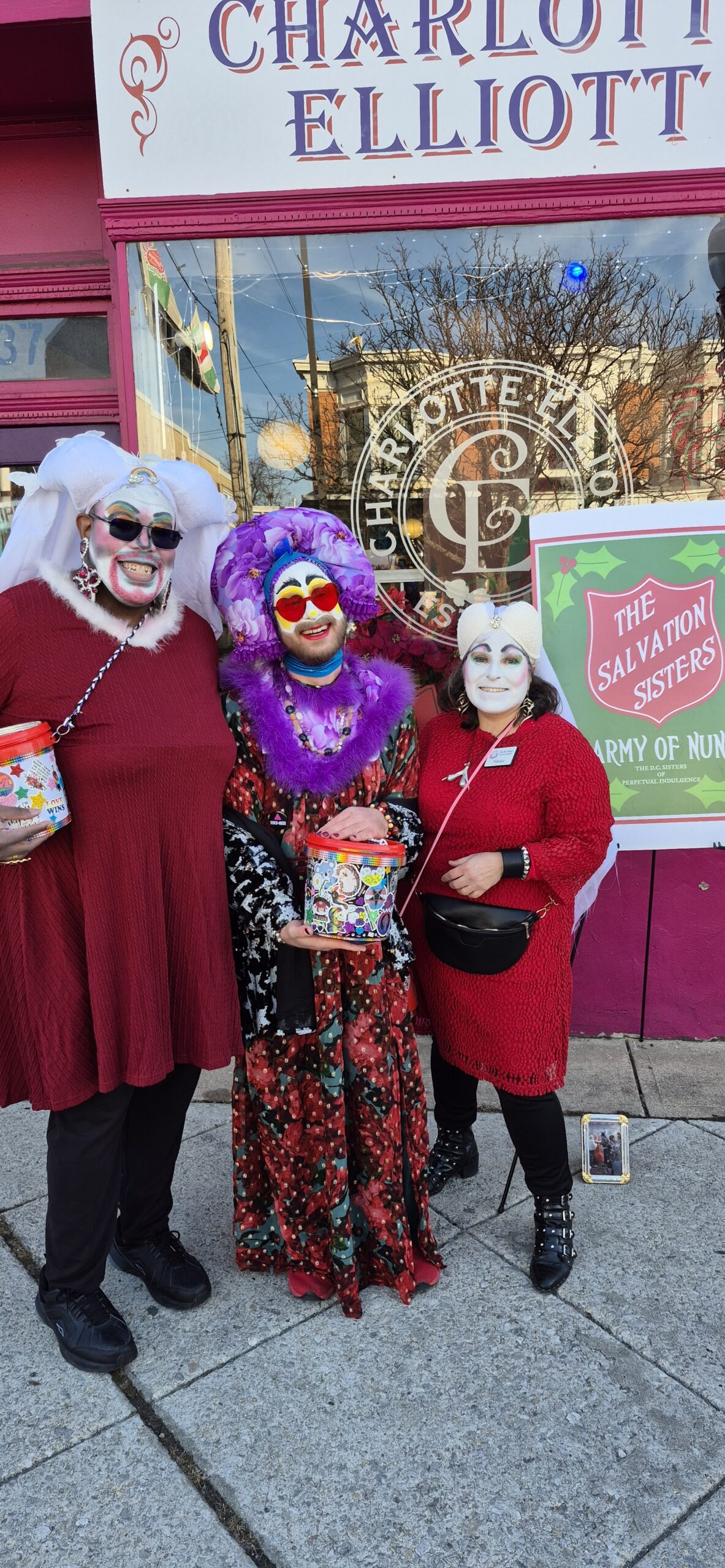 Three Sisters of Perpetual Indulgence standing in front of Charlote Elliott's bookstore in Baltimore